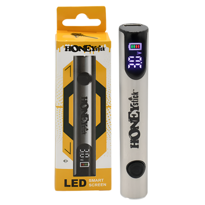 A HoneyStick Digital 510 Variable Voltage Battery in silver, displayed next to its packaging. The battery features an LED smart screen that shows voltage settings and battery life.