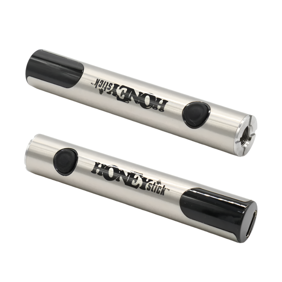 Two HoneyStick Digital 510 batteries positioned horizontally, showcasing the black and silver design, LED display, and 510 thread connection.
