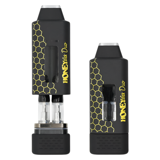 A black Honeystick Duo 510 thread vape battery with a honeycomb design, showcasing a dual cartridge system through a transparent window.