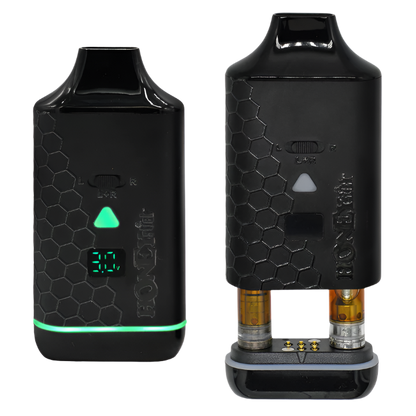 A black Honeystick Duo XL vape battery with a honeycomb design, LED display, voltage adjustment button, and cartridge selection switch.